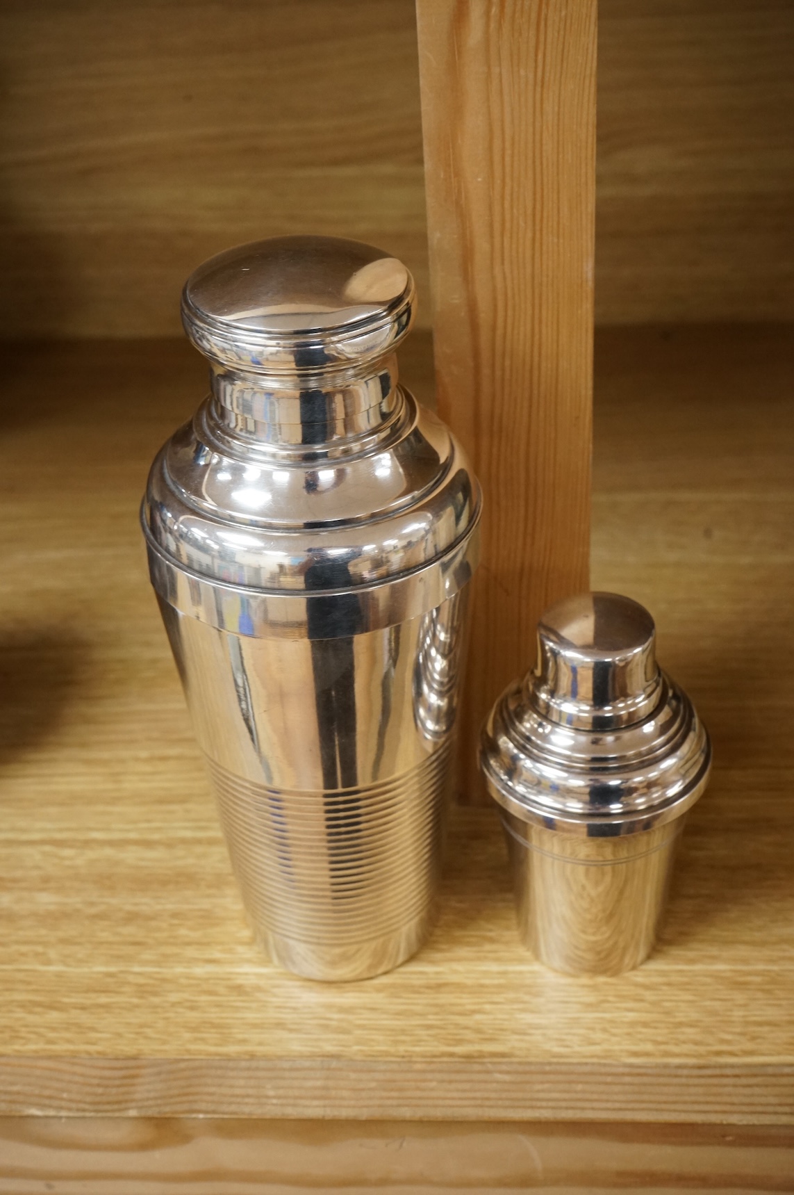 A small cocktail individual shaker and another larger example, 21cm high